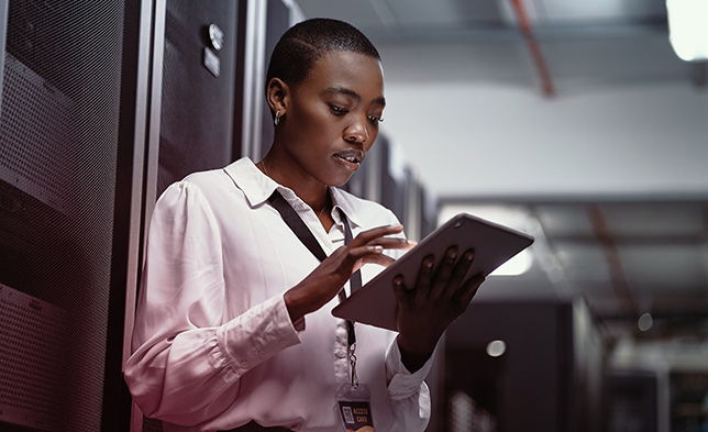 IT person using tablet in server room